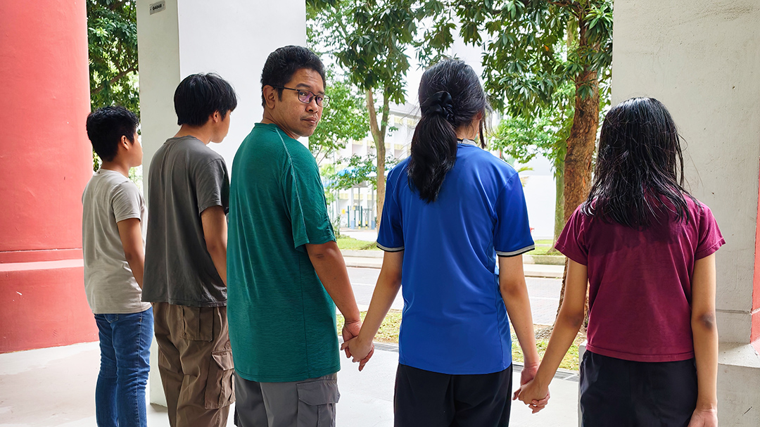 NTUC Care beneficiary Isham Abdul Latif (middle) with his four children.