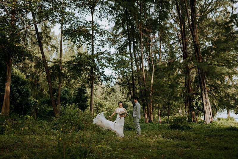 a photo of a couple in a forest landscape