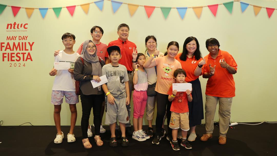 NTUC Secretary-General Ng Chee Meng with NTUC President K Thanaletchimi with stage games winners at NTUC May Day Family Fiesta.jpg