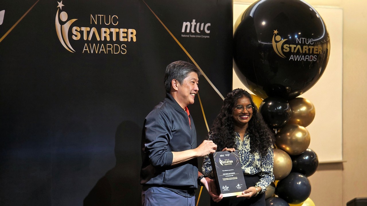 NTUC Secretary-General Ng Chee Meng congratulating Prithikka for successfully attaining the NTUC Starter Award.jpg