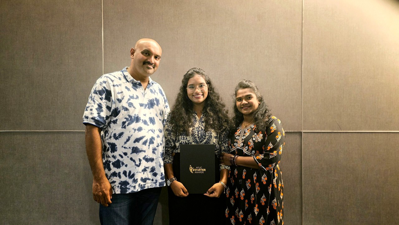 Prithikka Divyashini together with her proud parents after receiving the NTUC Starter Award.jpg