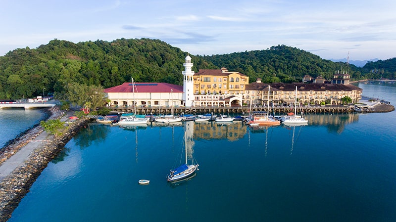 aerial footage over the water, facing a small riverside/seaside town