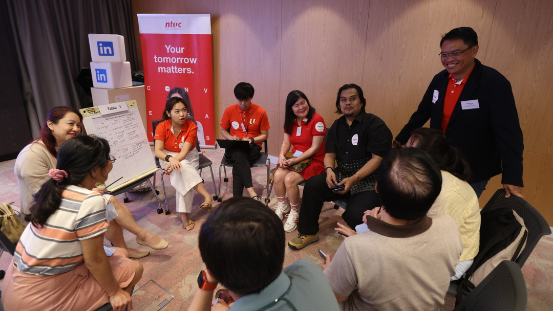 A group of people discussing work matters at an event.