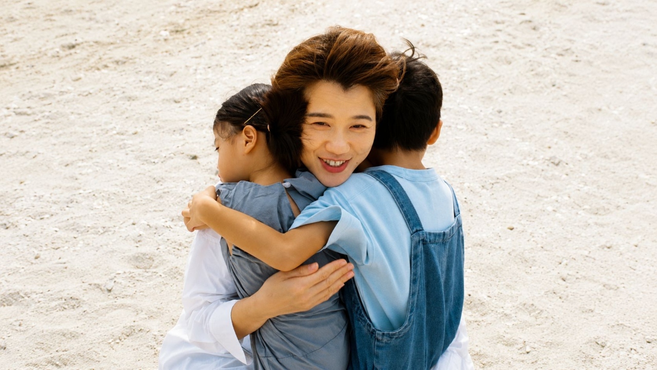 Aryen embracing her two children outdoors_1280.jpg