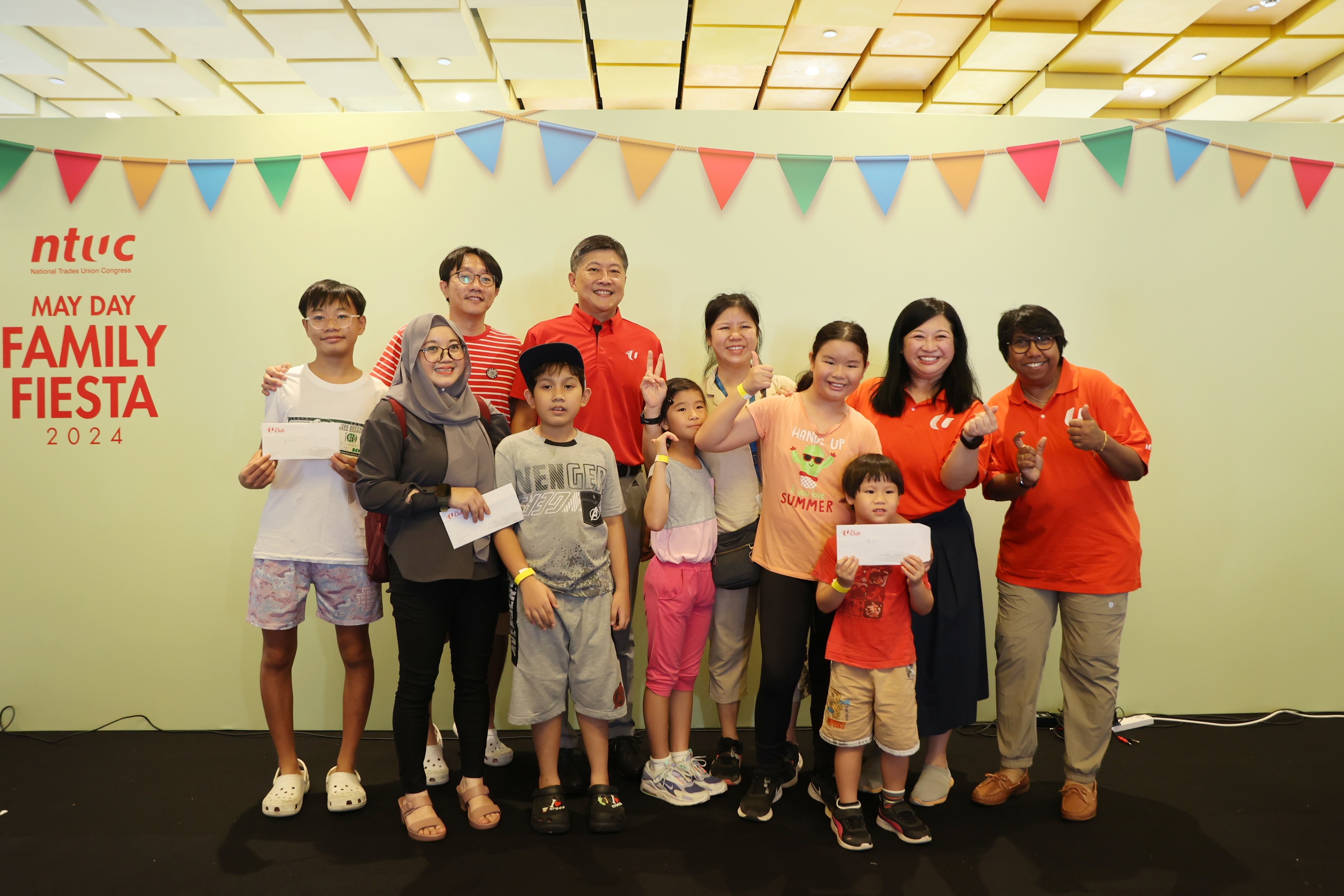 NTUC Secretary-General Ng Chee Meng with NTUC President K Thanaletchimi with stage games winners.jpg