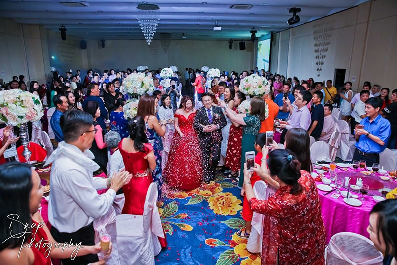 A couple being welcomed into a wedding celebration