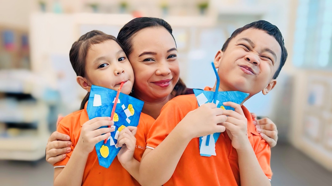 Cover image_Aishah Mahzan with her children Hizsyafiyah and Hisziqri displaying their artwork from Bright Horizons Fund art classes at My First Skool_1080.jpg